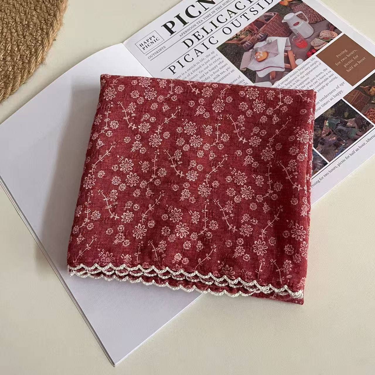 Folded red floral fabric handkerchief on a newspaper background